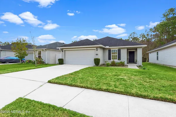 a view of a house with a yard