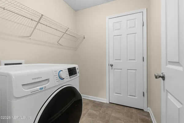 a view of a backyard with table and chairs with wooden fence