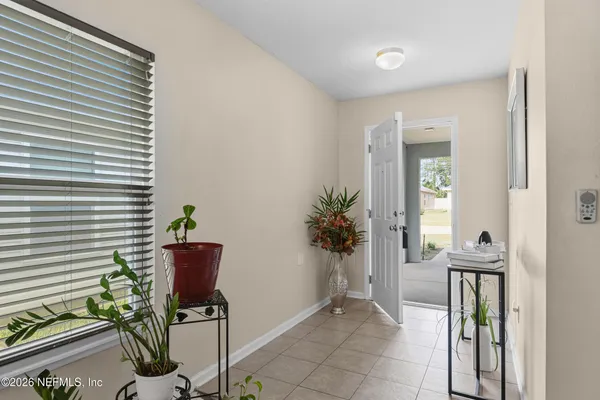 a living room with furniture and a dining table