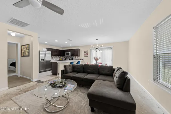 a living room with furniture a clock and a window