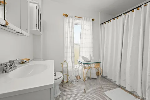 a bathroom with a sink a toilet and a tub