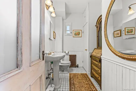 a bathroom with a sink a toilet and a mirror