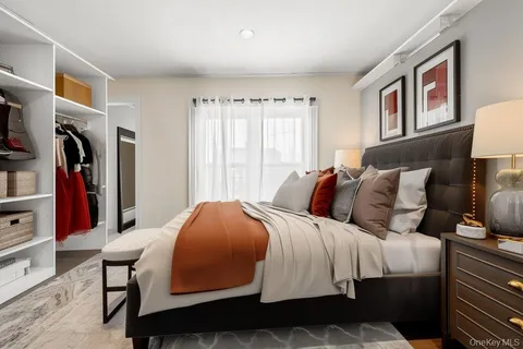 a bedroom with a large bed and a window