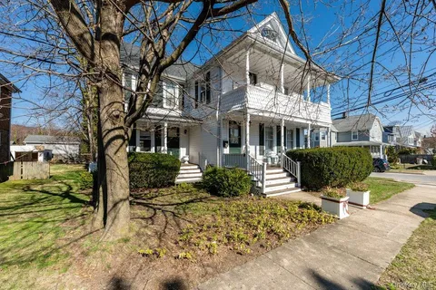 a front view of a house with garden and patio
