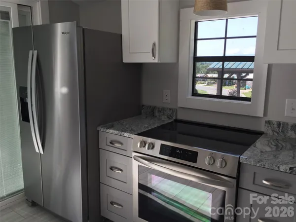 a stove top oven sitting inside of a kitchen