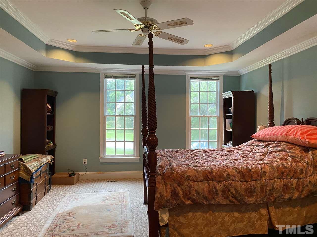 3904 Hemsbury Way Raleigh, NC 27612 - Photo 11 of 20 a bedroom with a bed and a dresser next to a window