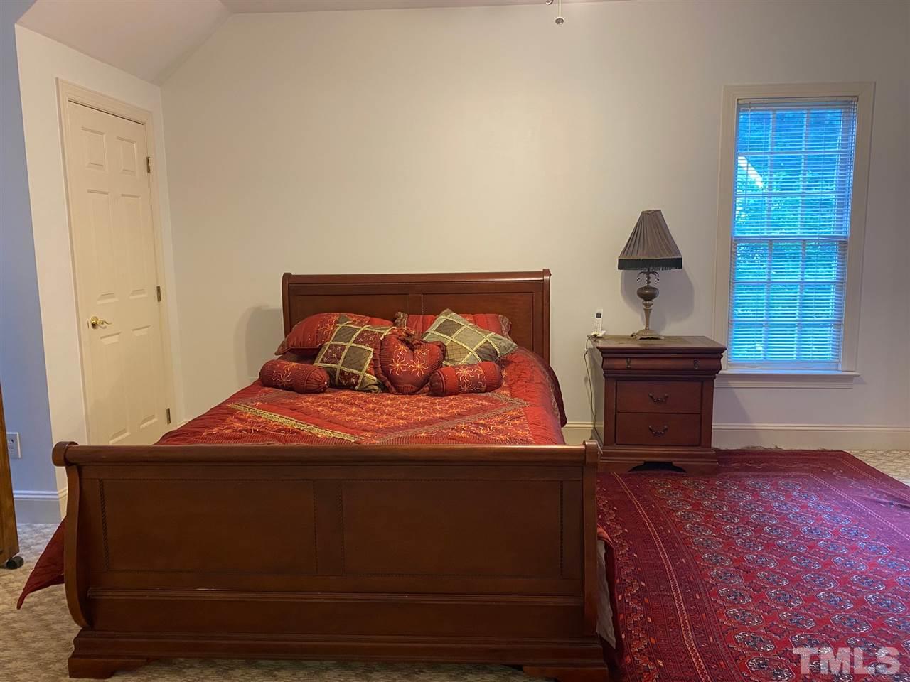 3904 Hemsbury Way Raleigh, NC 27612 - Photo 12 of 20 a bedroom with a bed and a window