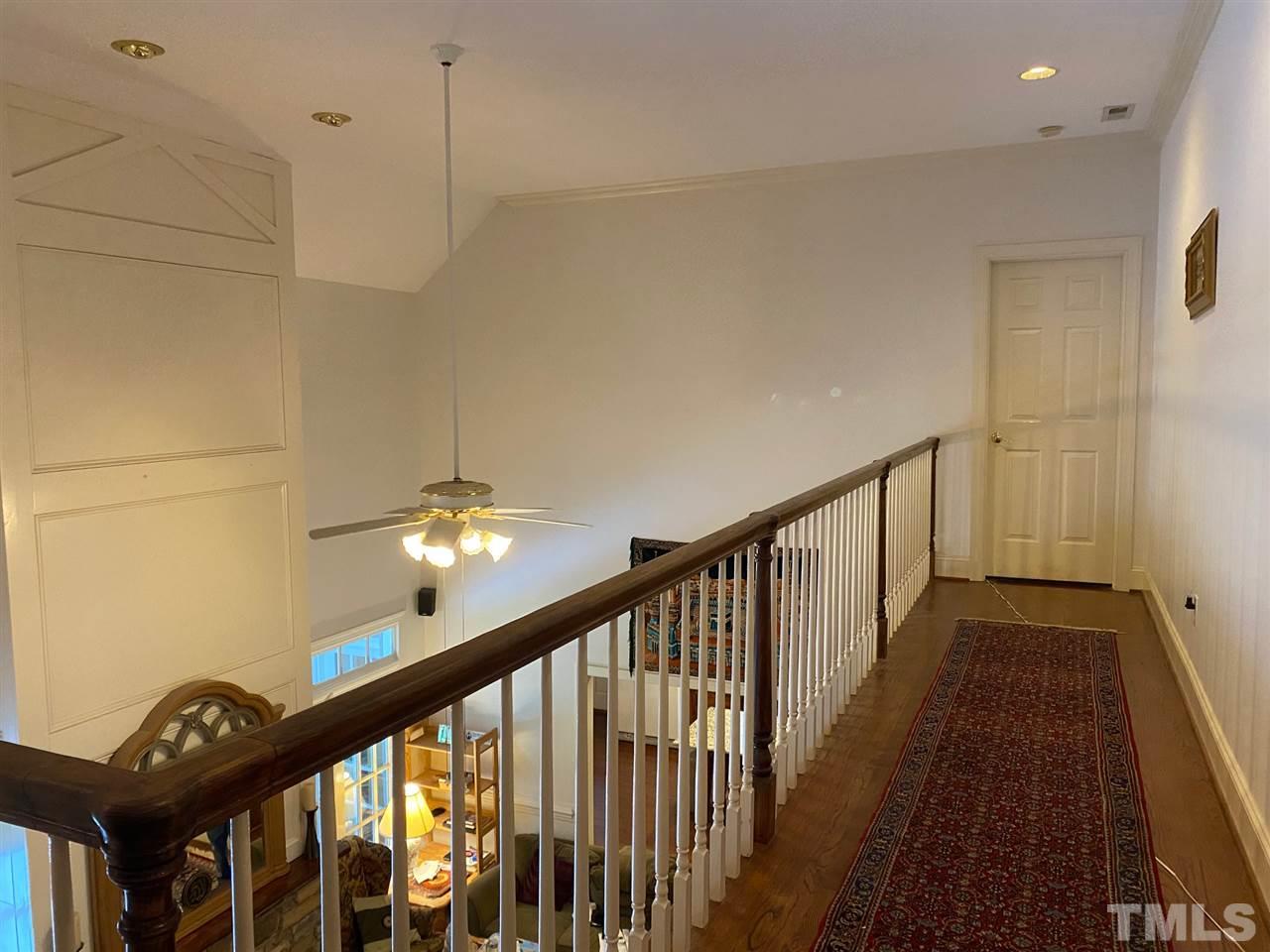 3904 Hemsbury Way Raleigh, NC 27612 - Photo 13 of 20 a view of a hallway with wooden floor