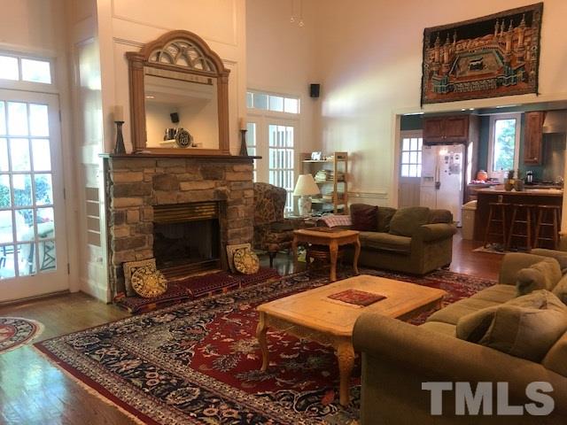 3904 Hemsbury Way Raleigh, NC 27612 - Photo 3 of 20 a living room with furniture and a fireplace