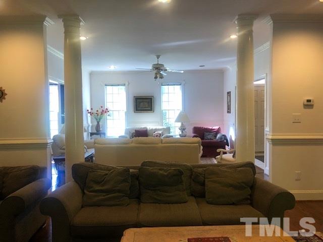 3904 Hemsbury Way Raleigh, NC 27612 - Photo 6 of 20 a living room with furniture and a chandelier