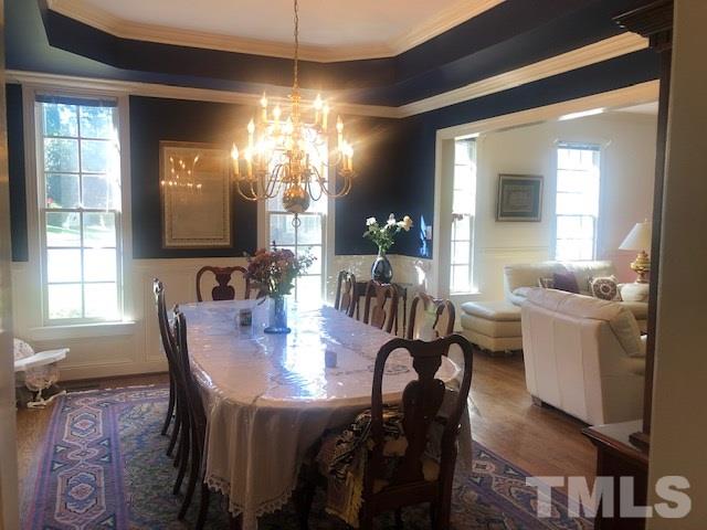 3904 Hemsbury Way Raleigh, NC 27612 - Photo 8 of 20 a view of a a dining room with furniture window and wooden floor