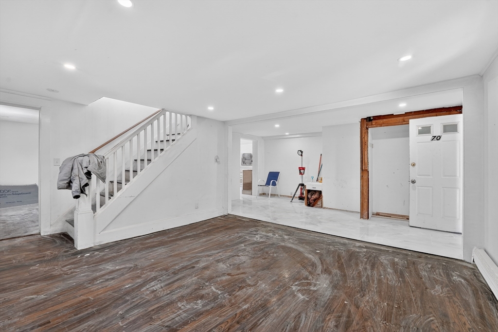 70 Brush Hill Road Milton, MA 02186 - Photo 14 of 26 a view of a livingroom with wooden floor and stairs