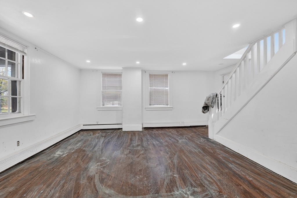 70 Brush Hill Road Milton, MA 02186 - Photo 15 of 26 a view of an empty room with wooden floor and stairs