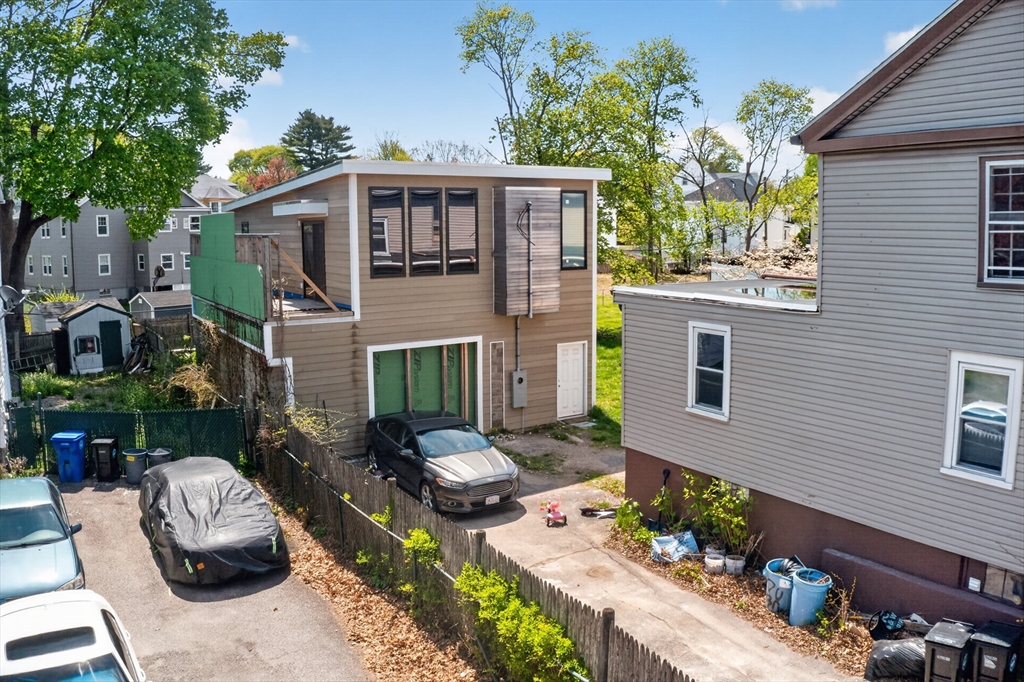 70 Brush Hill Road Milton, MA 02186 - Photo 17 of 26 a front view of a house with outdoor seating