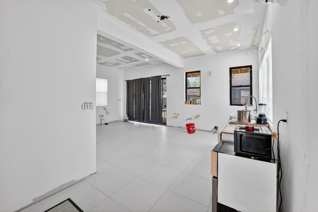 70 Brush Hill Road Milton, MA 02186 - Photo 7 of 26 a view of a livingroom and a kitchen