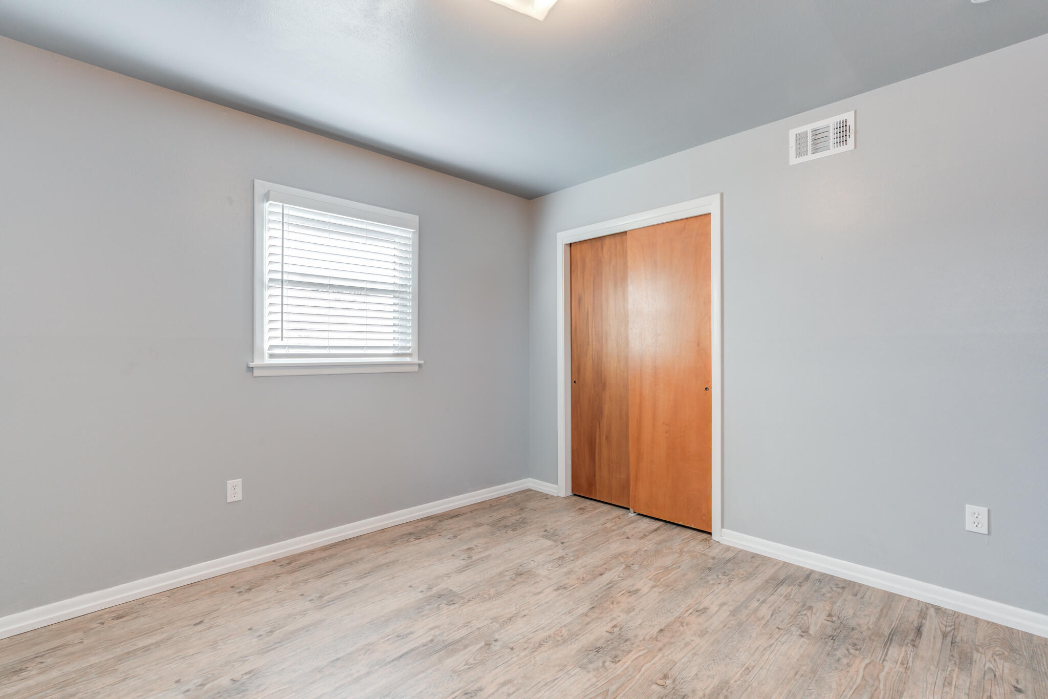 2806 60th Street Lubbock, TX 79413 - Photo 13 of 13 a view of an empty room with wooden floor and a window