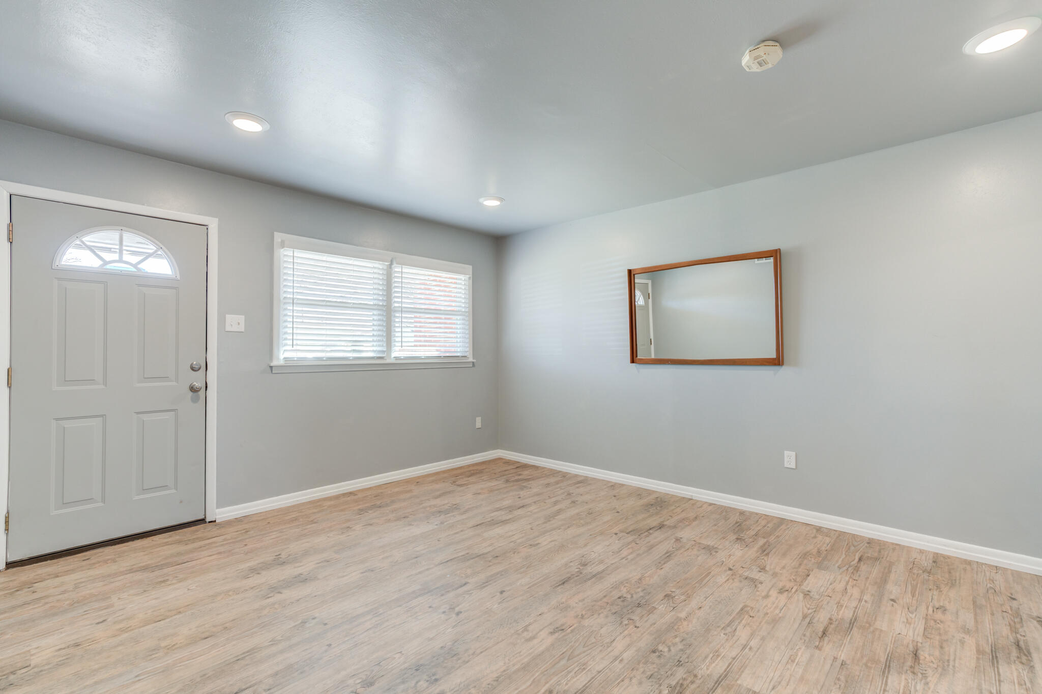 2806 60th Street Lubbock, TX 79413 - Photo 3 of 13 a view of empty room with wooden floor and fan
