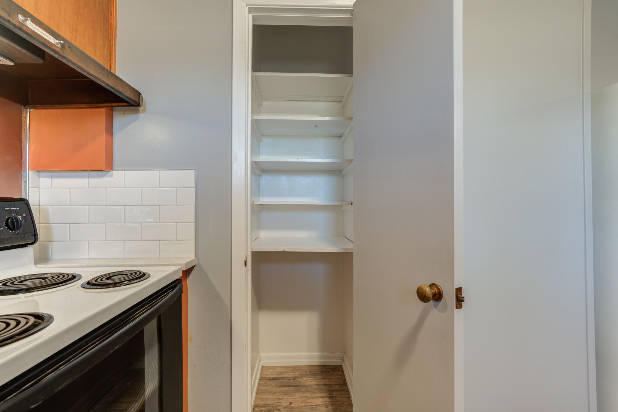 2806 60th Street Lubbock, TX 79413 - Photo 8 of 13 a kitchen with a stove and a cabinet
