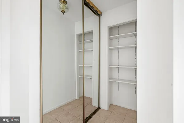 an empty room with windows and ceiling fan