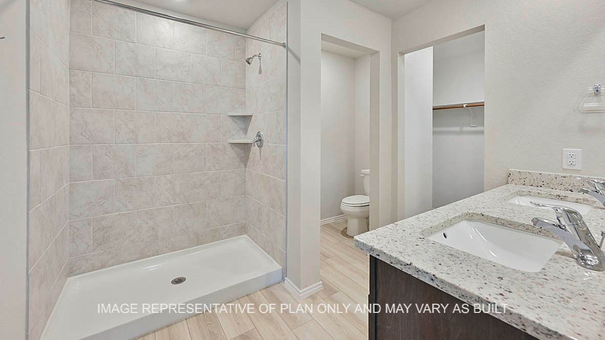 5538 Harriet Street Bryan, TX 77807 - Photo 12 of 17 a bathroom with a granite countertop sink and a bathtub