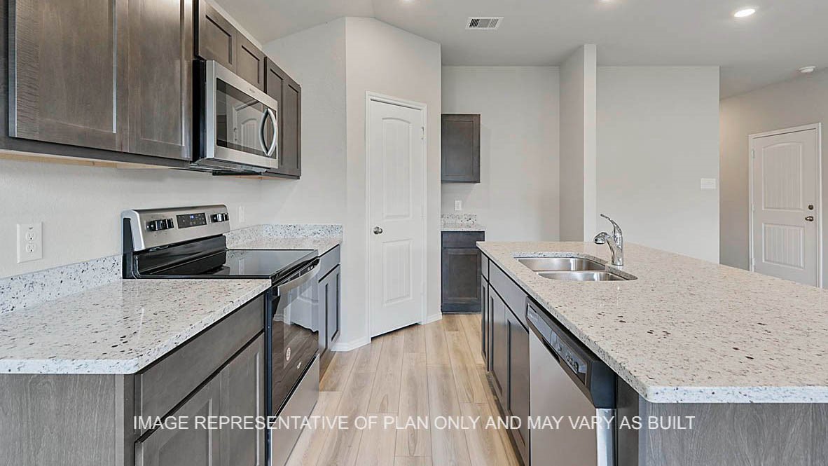 5538 Harriet Street Bryan, TX 77807 - Photo 5 of 17 a kitchen with a sink stove and microwave