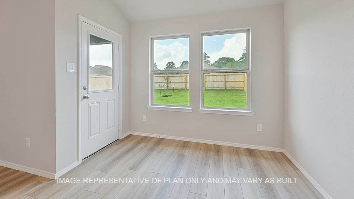 5538 Harriet Street Bryan, TX 77807 - Photo 9 of 17 an empty room with wooden floor and windows