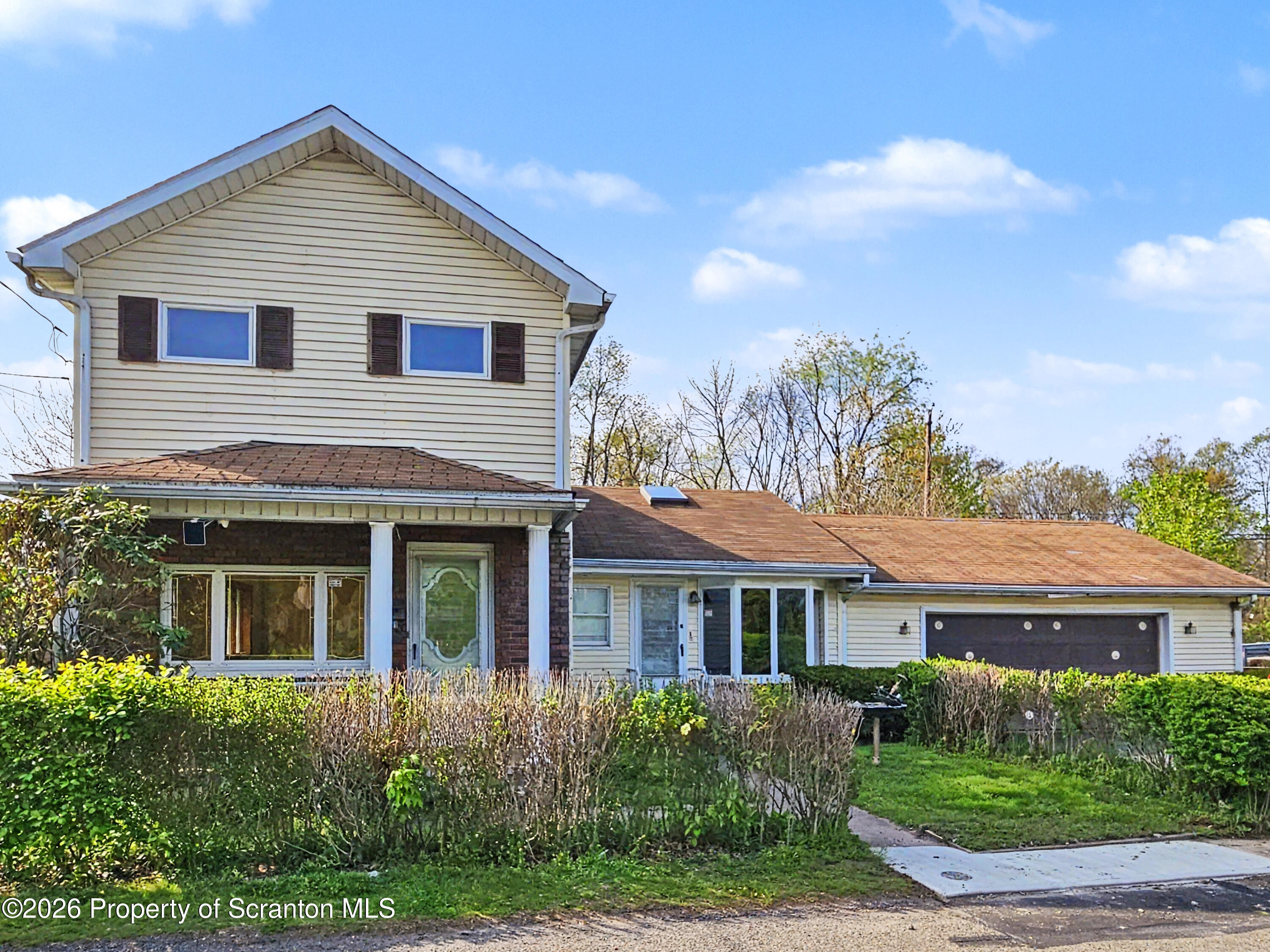 134 Lampman Street Avoca, PA 18641 - Photo 1 of 22 a front view of a house with garden and garage