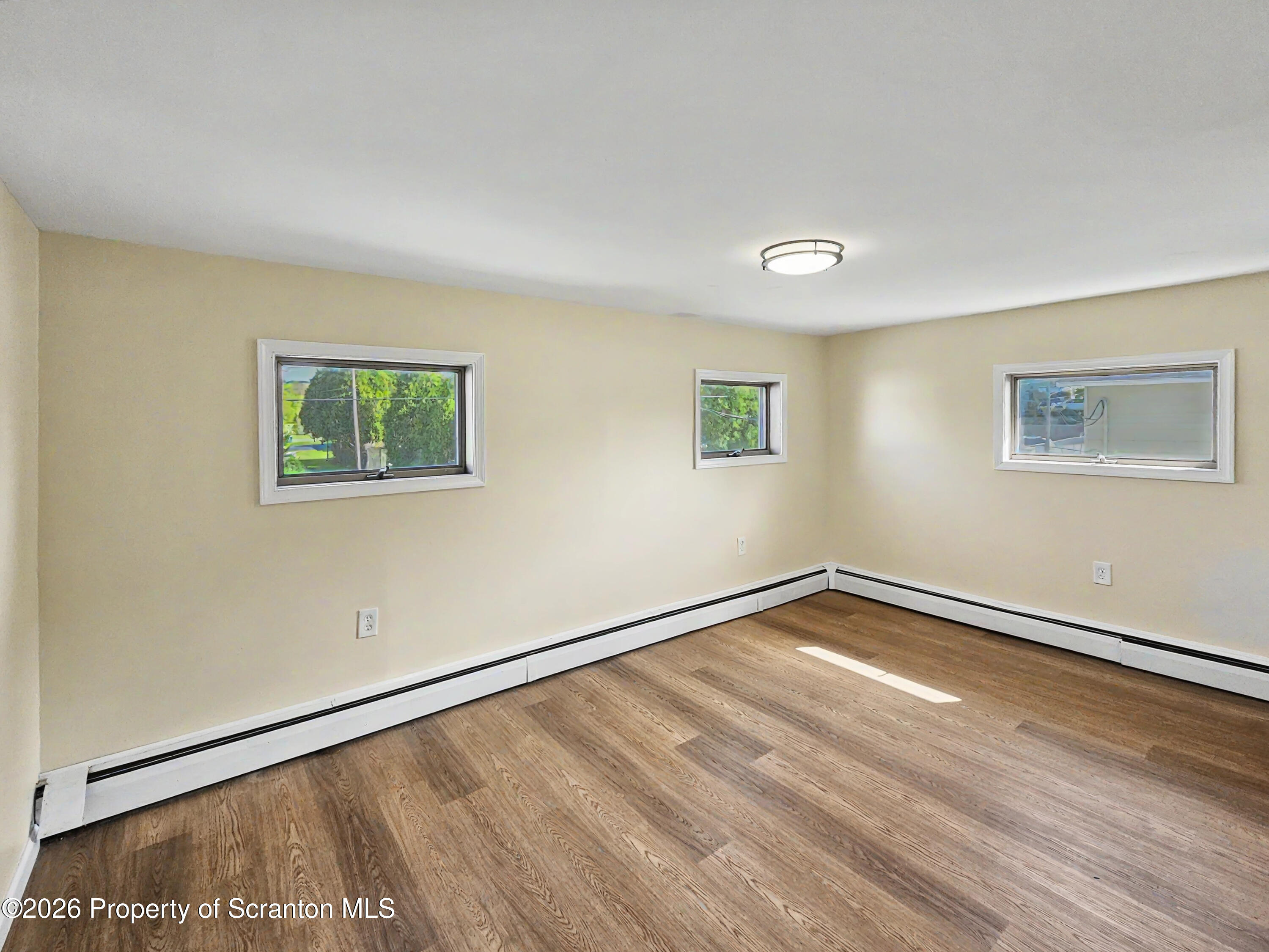 134 Lampman Street Avoca, PA 18641 - Photo 11 of 22 a view of a room with wooden floor and white walls