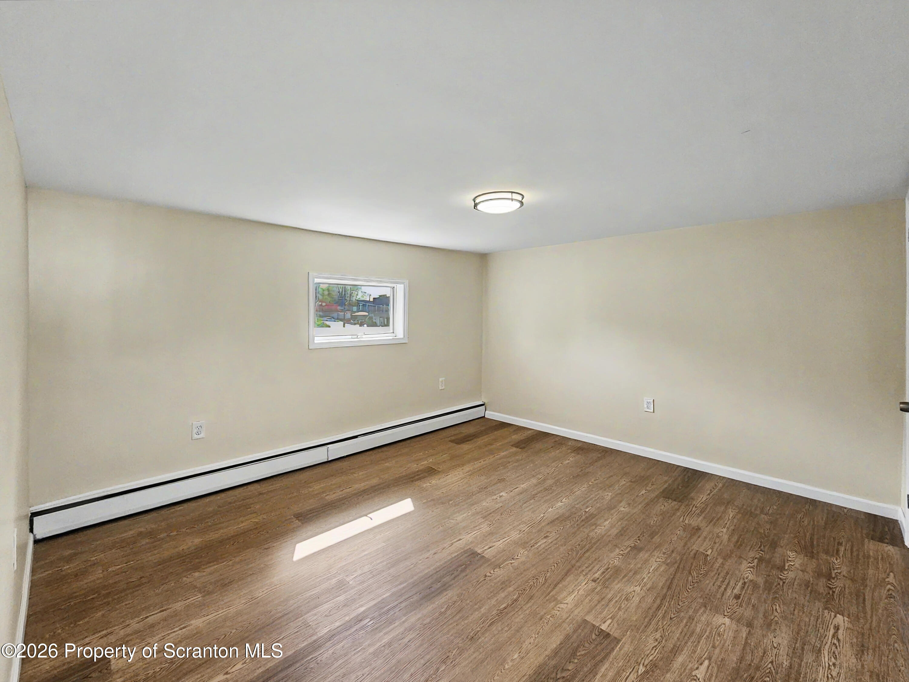 134 Lampman Street Avoca, PA 18641 - Photo 13 of 22 a view of a big room with wooden floor and windows