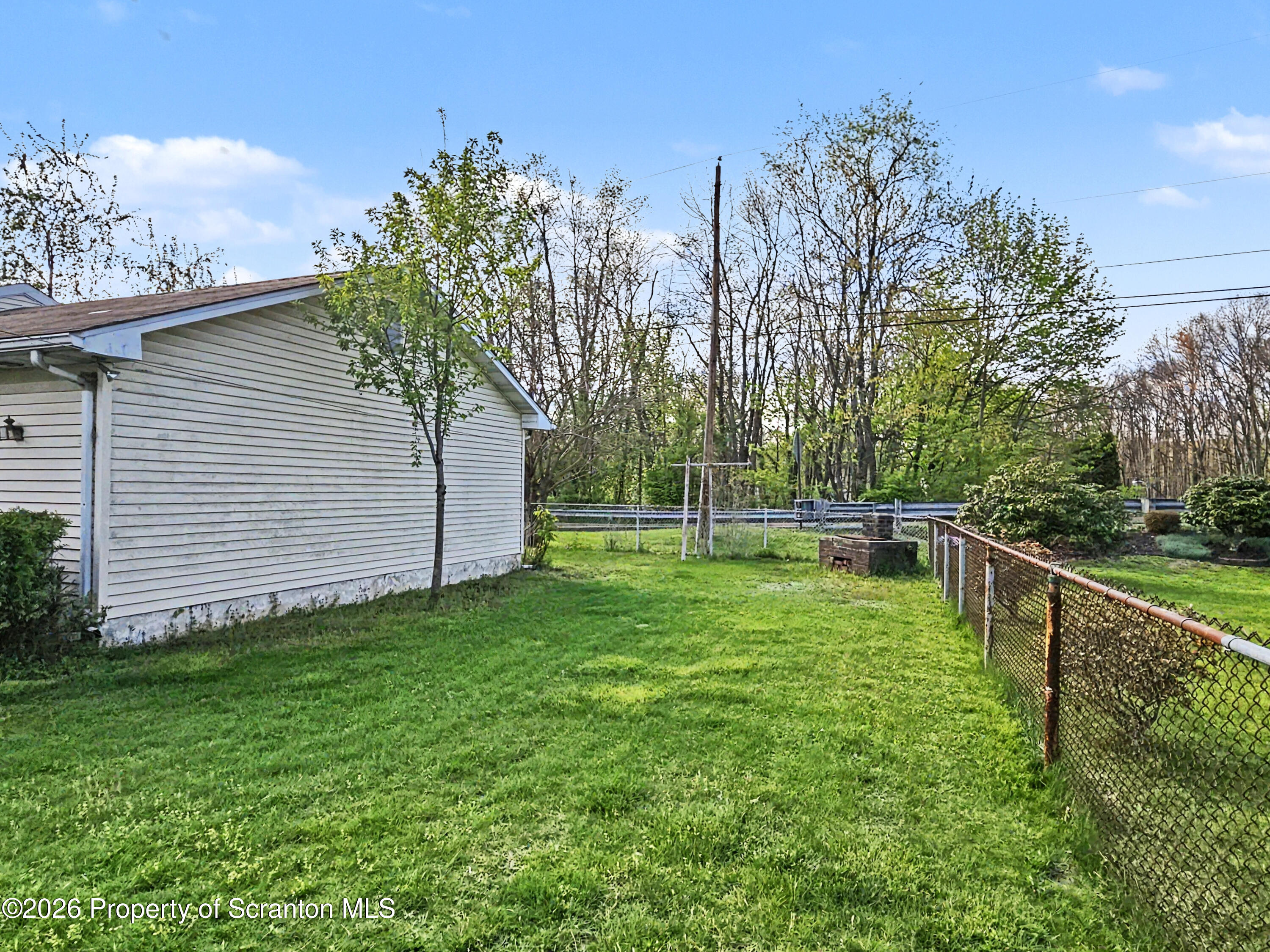 134 Lampman Street Avoca, PA 18641 - Photo 21 of 22 a view of a backyard with large trees