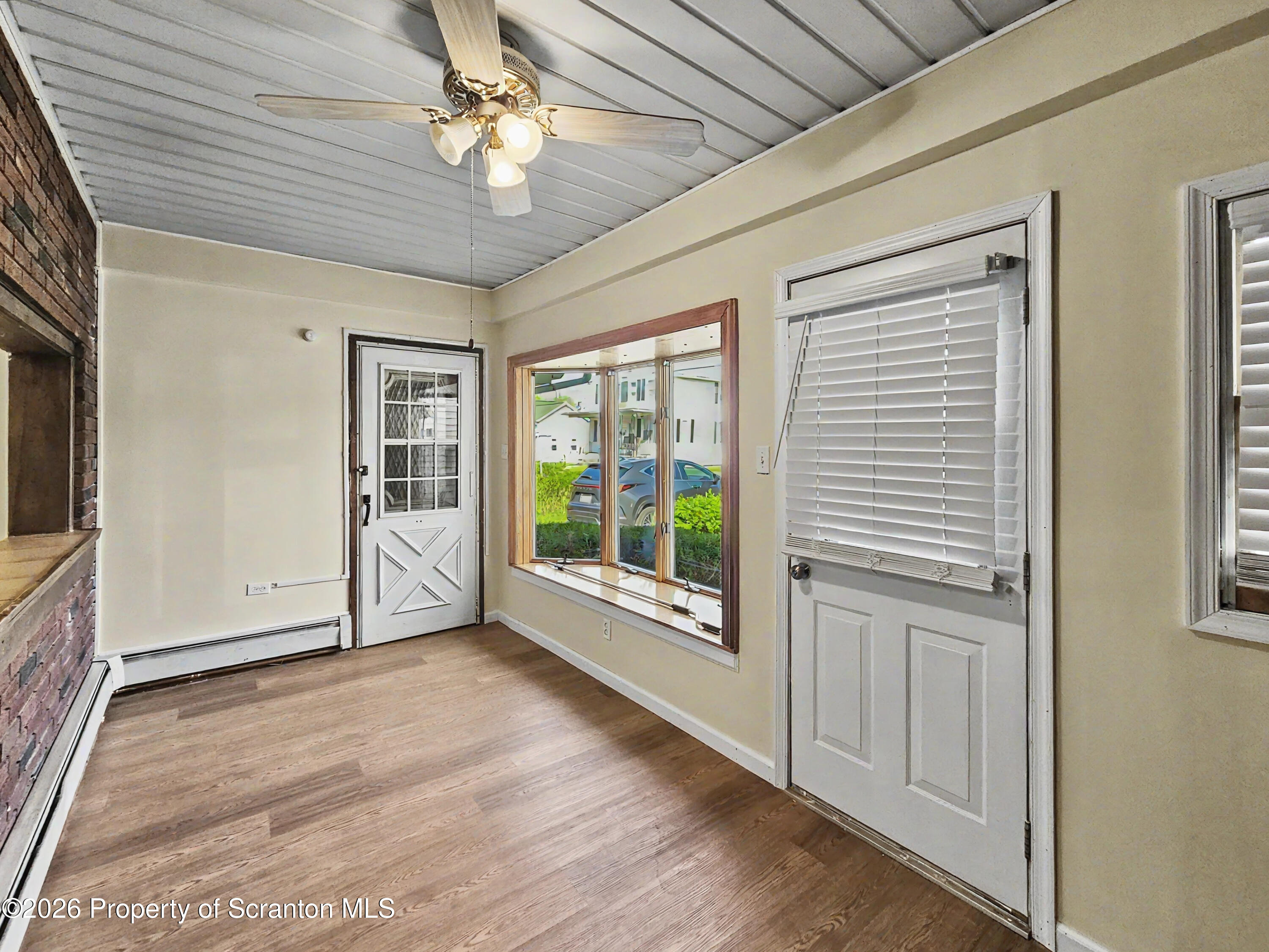 134 Lampman Street Avoca, PA 18641 - Photo 4 of 22 a view of an empty room with a window and wooden floor