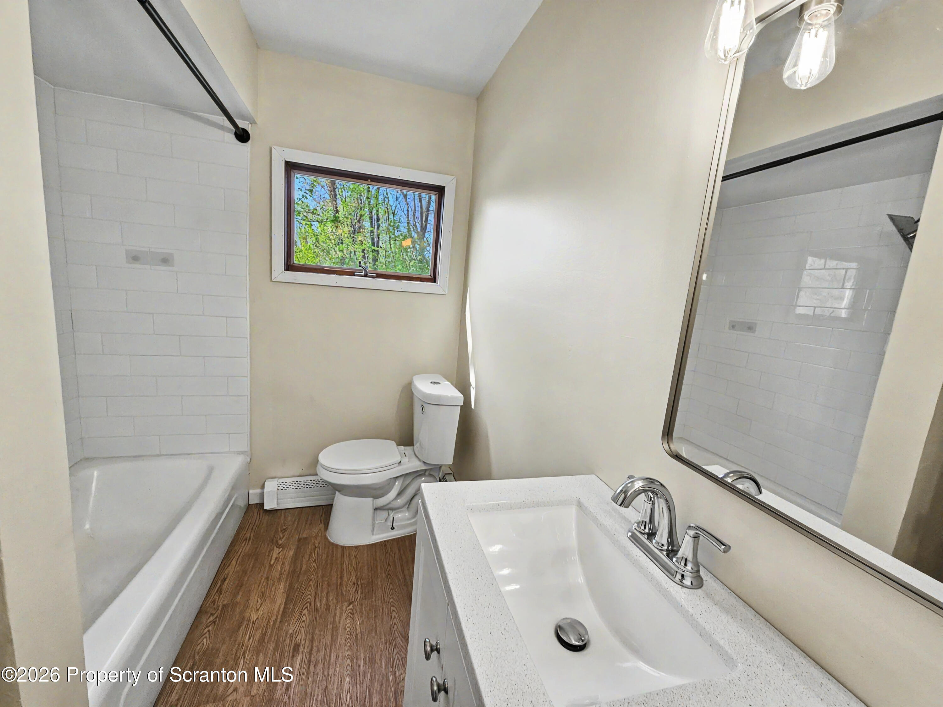 134 Lampman Street Avoca, PA 18641 - Photo 5 of 22 a bathroom with a sink a toilet and shower