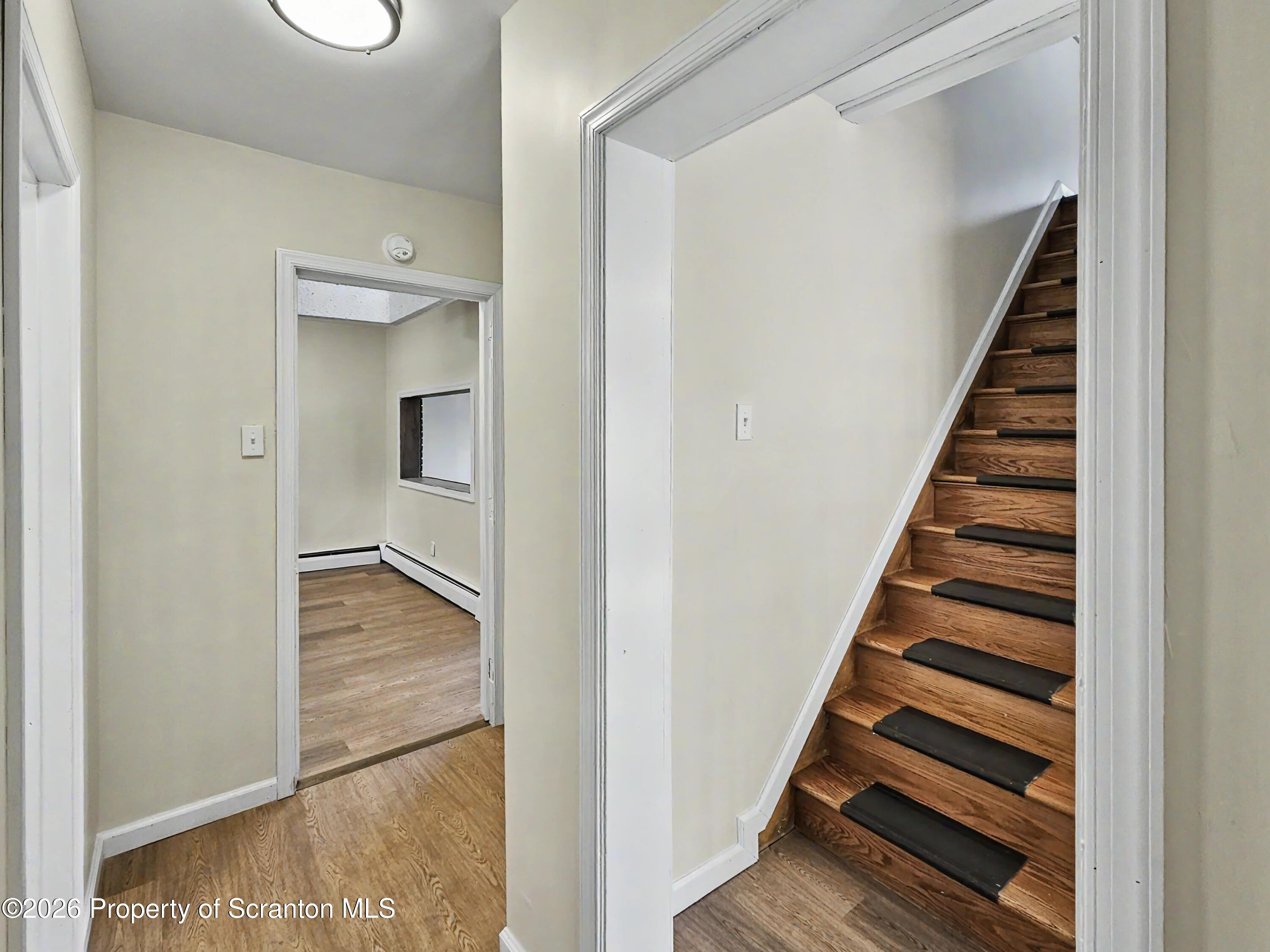 134 Lampman Street Avoca, PA 18641 - Photo 10 of 22 a view of a hallway with wooden floor and entryway