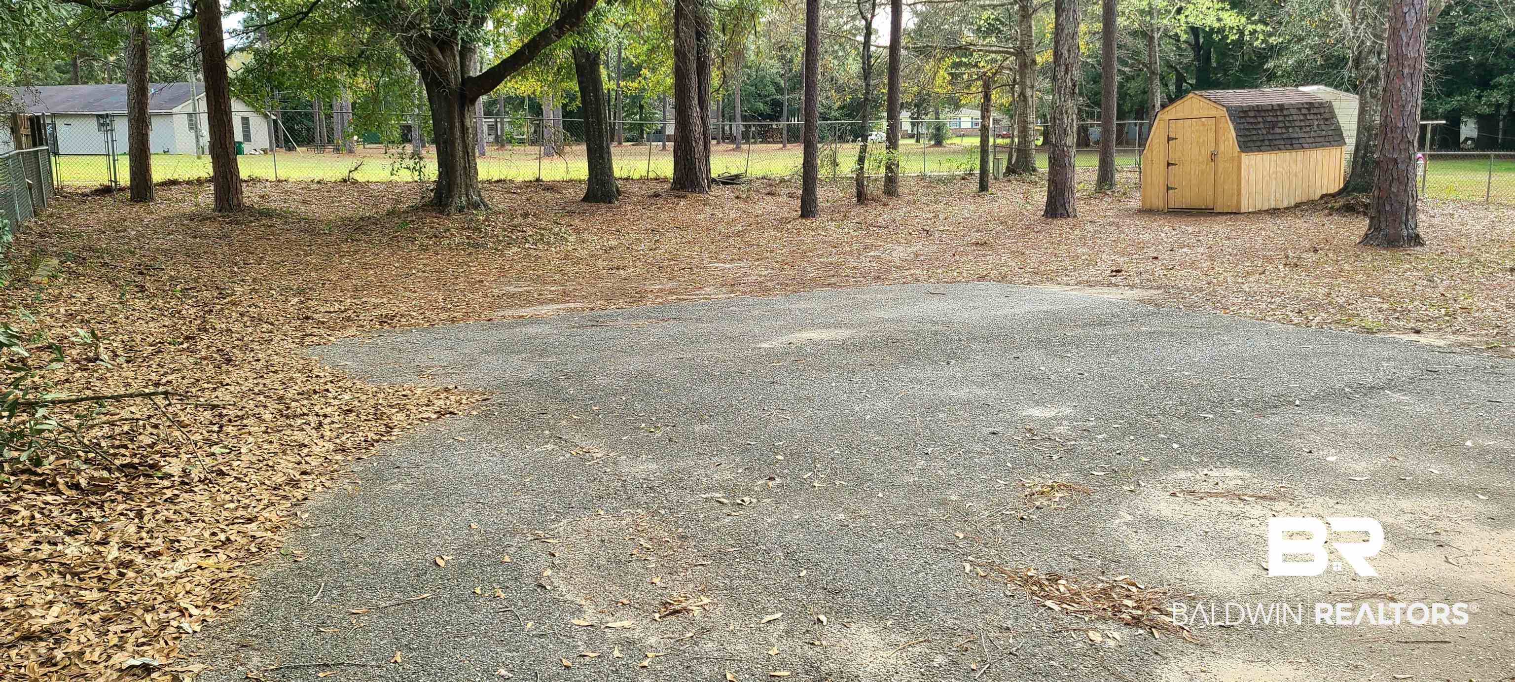 5305 Wilhelm Drive Mobile, AL 36618 - Photo 14 of 16 View of yard with fence, an outdoor structure, and a shed