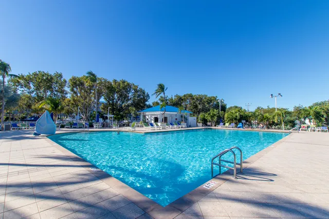 a swimming pool with outdoor seating and yard