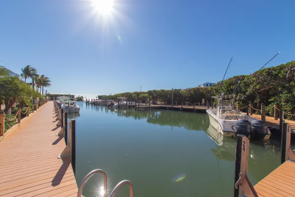 a view of a lake with boats and trees in the background