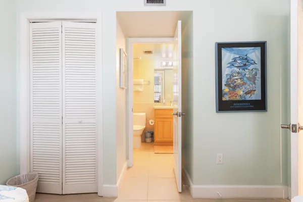 a bedroom with a bed and a view of bathroom