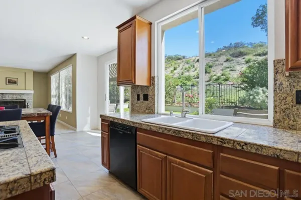a kitchen with a stove a table and chairs in it