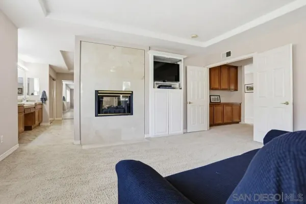 a living room with furniture and ceiling fan