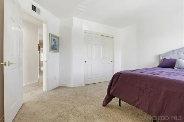a bedroom with a bed and a lamp