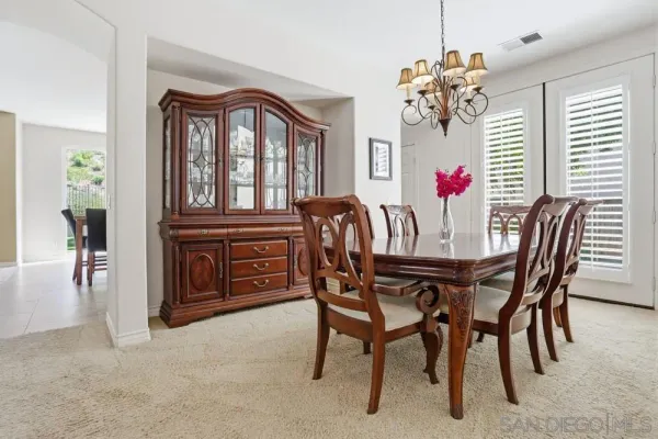 a view of a dining room with furniture and chandelier