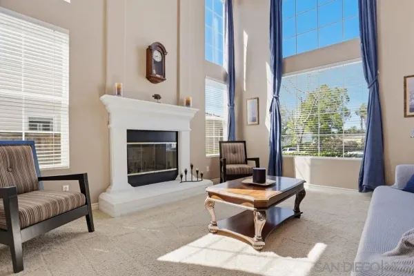 a living room with furniture a fireplace and a table