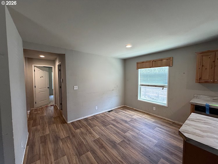 16125 Hawks Lair Road La Pine, OR 97739 - Photo 5 of 35 an empty room with wooden floor and a window