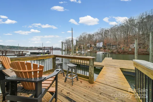 a view of a balcony with wooden floor and outdoor seating
