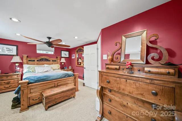 a bedroom with a bed and painting on the wall