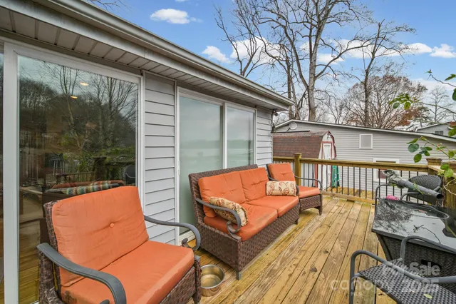 a wooden bench sitting in front of a building