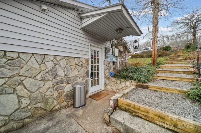 a view of a house with a wooden deck