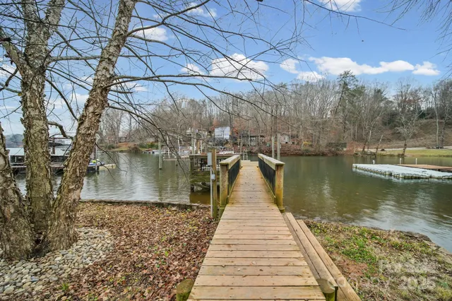 a view of residential houses with outdoor space and lake view