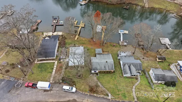 an aerial view of a house with a lake view