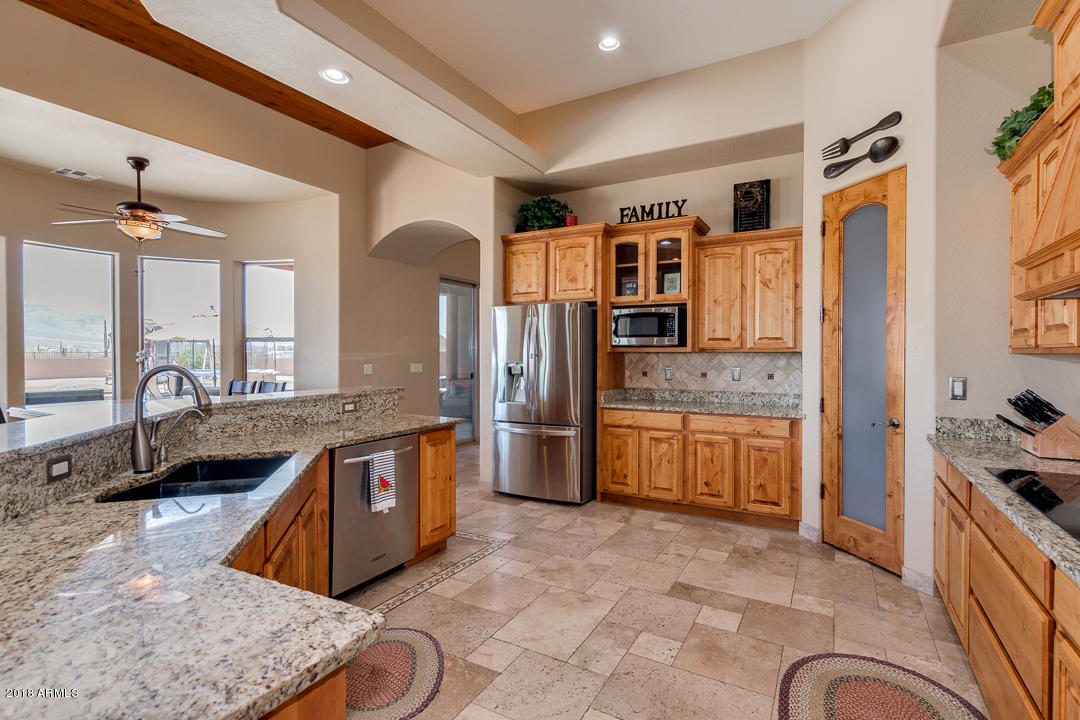 1982 North Goldfield Road Apache Junction, AZ 85119 - Photo 16 of 86 a large kitchen with stainless steel appliances granite countertop a stove and a sink